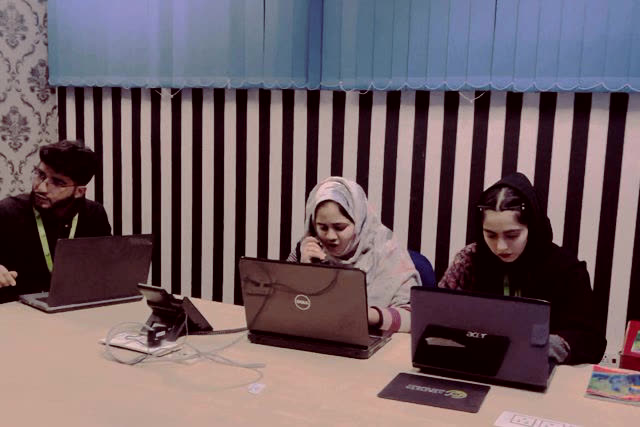 Team working on laptops in the cloud